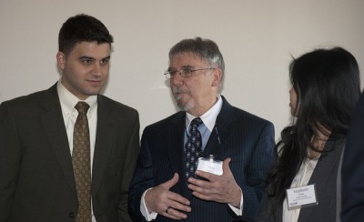 Dr. Michael Goupil, assistant dean of dental student affairs, talks with students during the Student Research Day Awards Banquet.