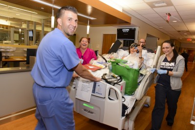 UConn Health nursing staff wheel a patient into the new hospital tower. (Photo by Janine Gelineau)